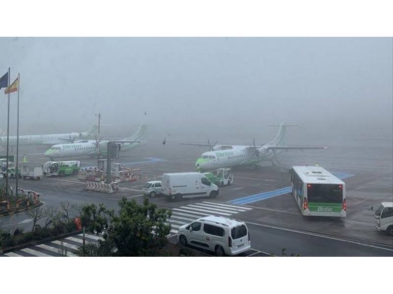 Foggy weather conditions at Tenerife North Airport causing flight disruptions with Binter Canarias planes on the tarmac.